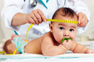 Newborn Medical Exam - Doctor Checking Head Size with a